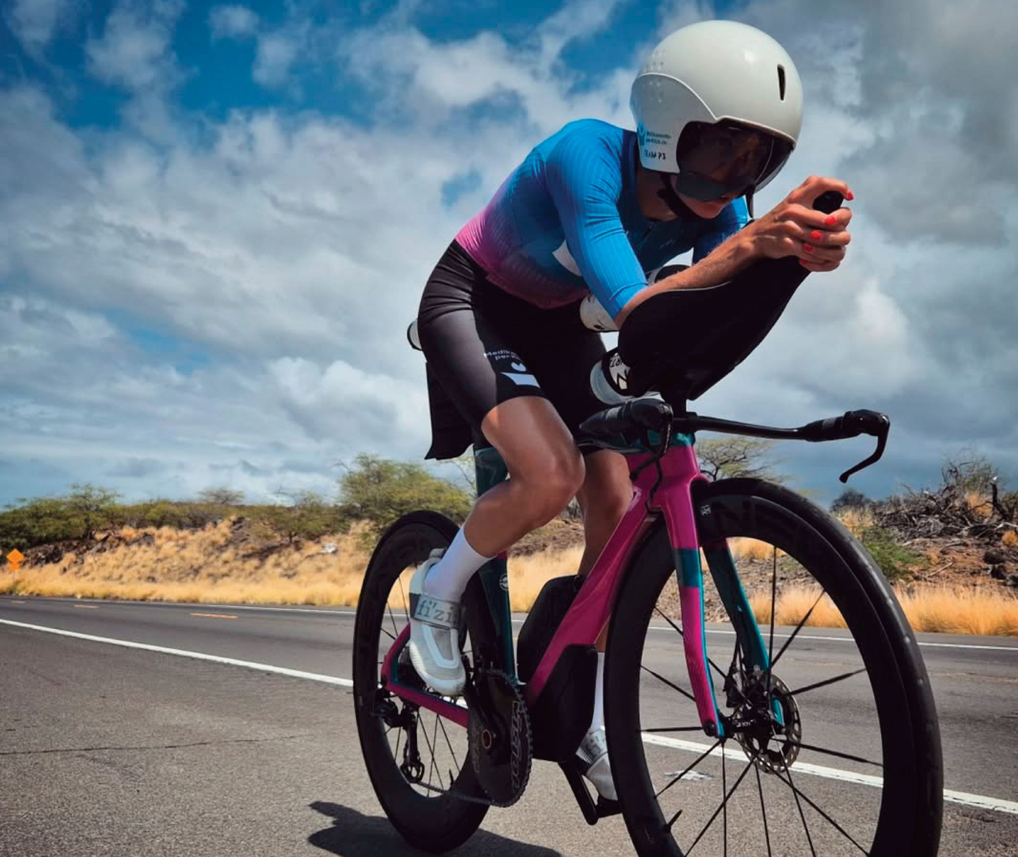 DTR athlete Julia Skala on the bike at Ironman Kona wearing custom DTR trisuit — long distance triathlon apparel