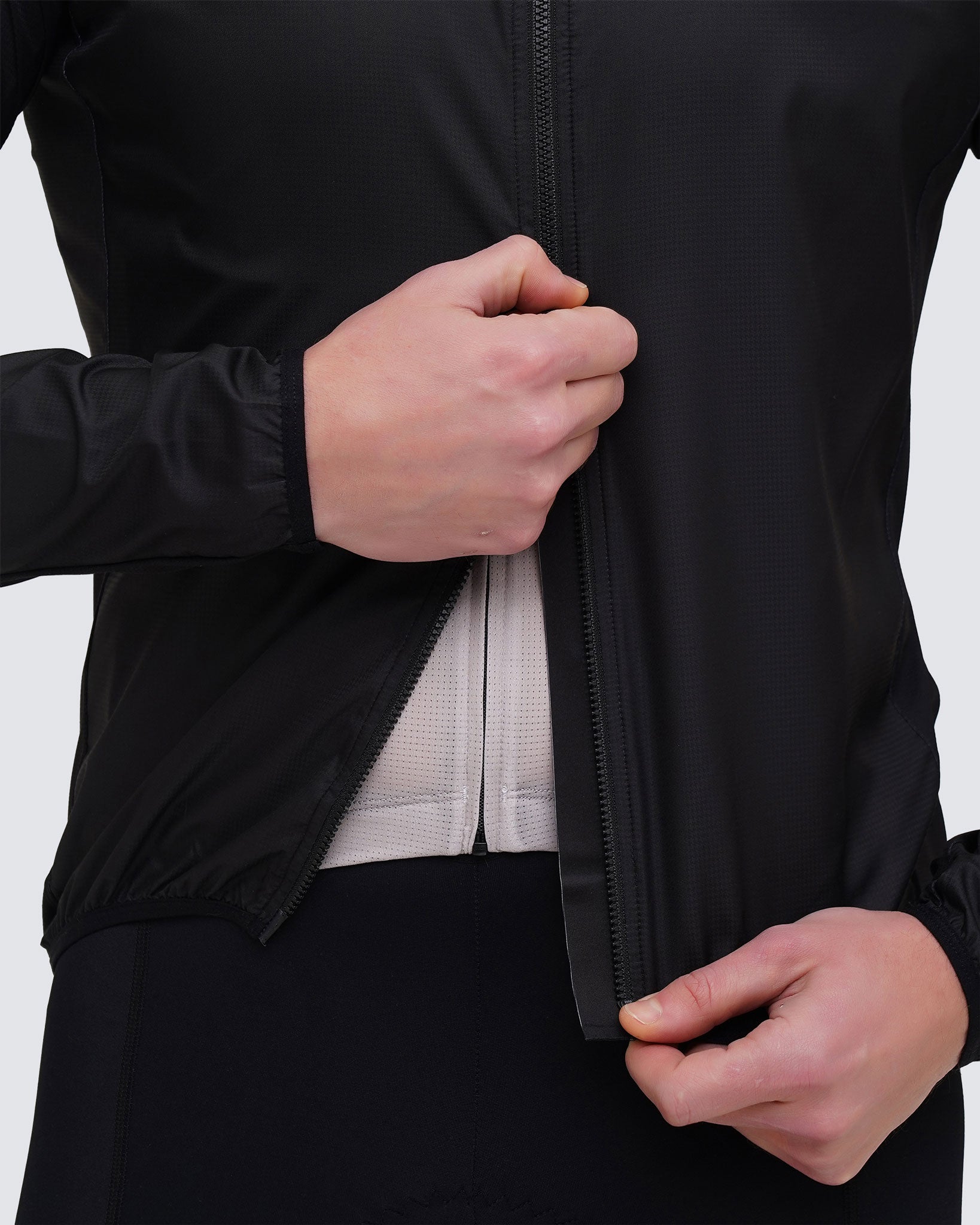 Racing black Men cycling windbreaker two ways zipper close up opening from the bottom