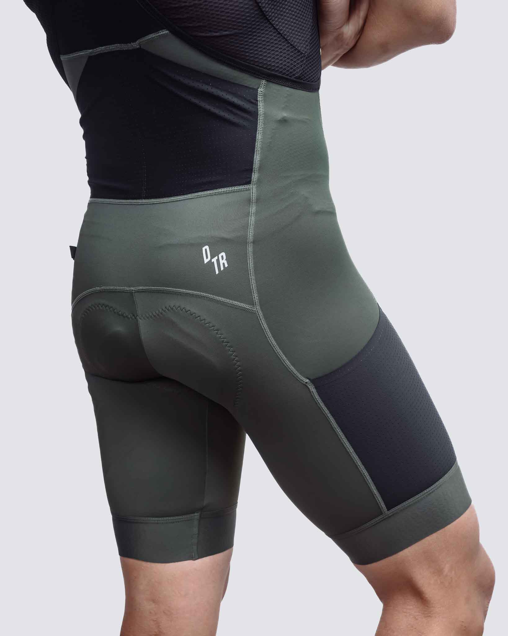 back of green man cycling cargo bibs