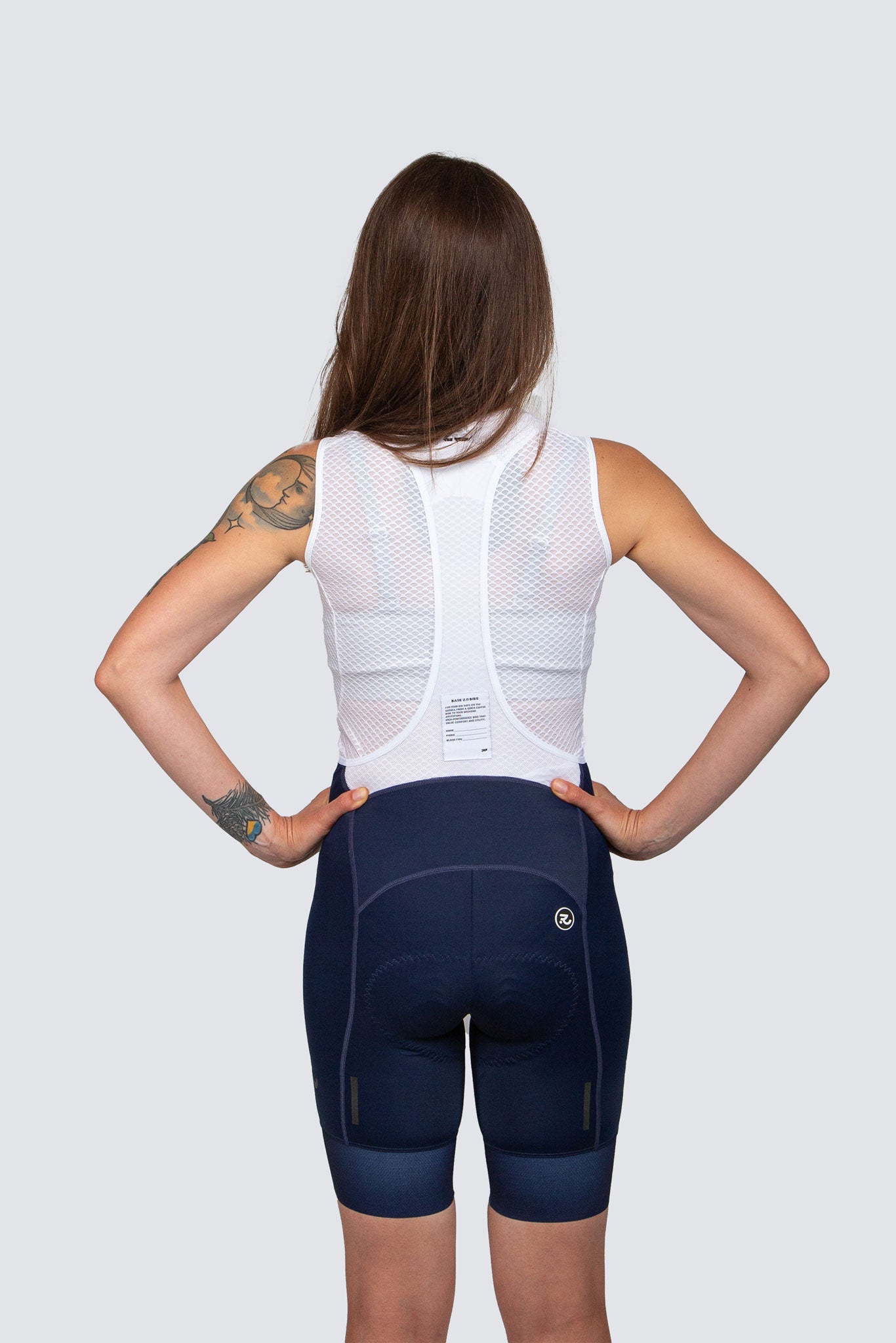 back of white base layer and blue bib shorts