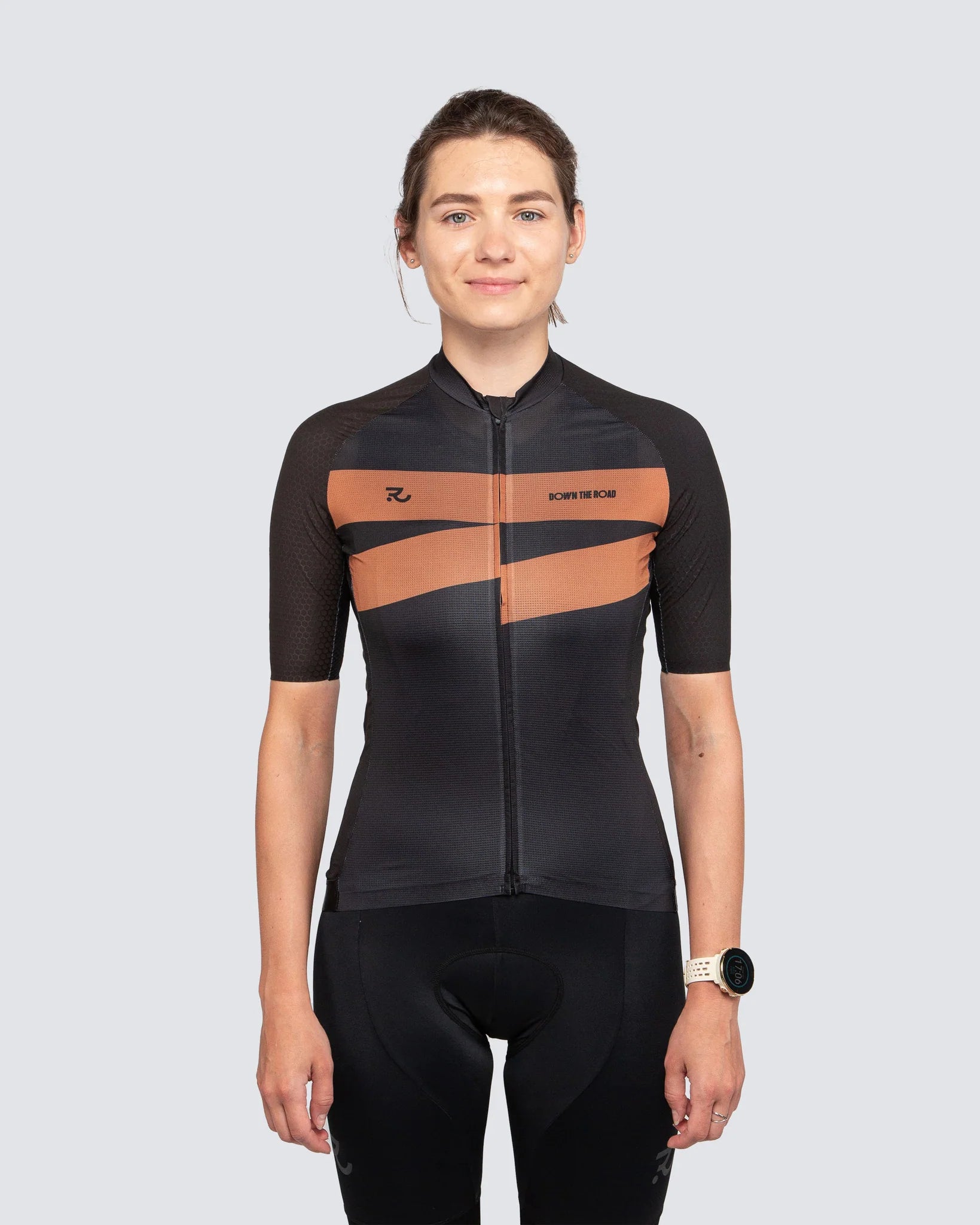 young woman wearing a black cycling jersey and bib shorts