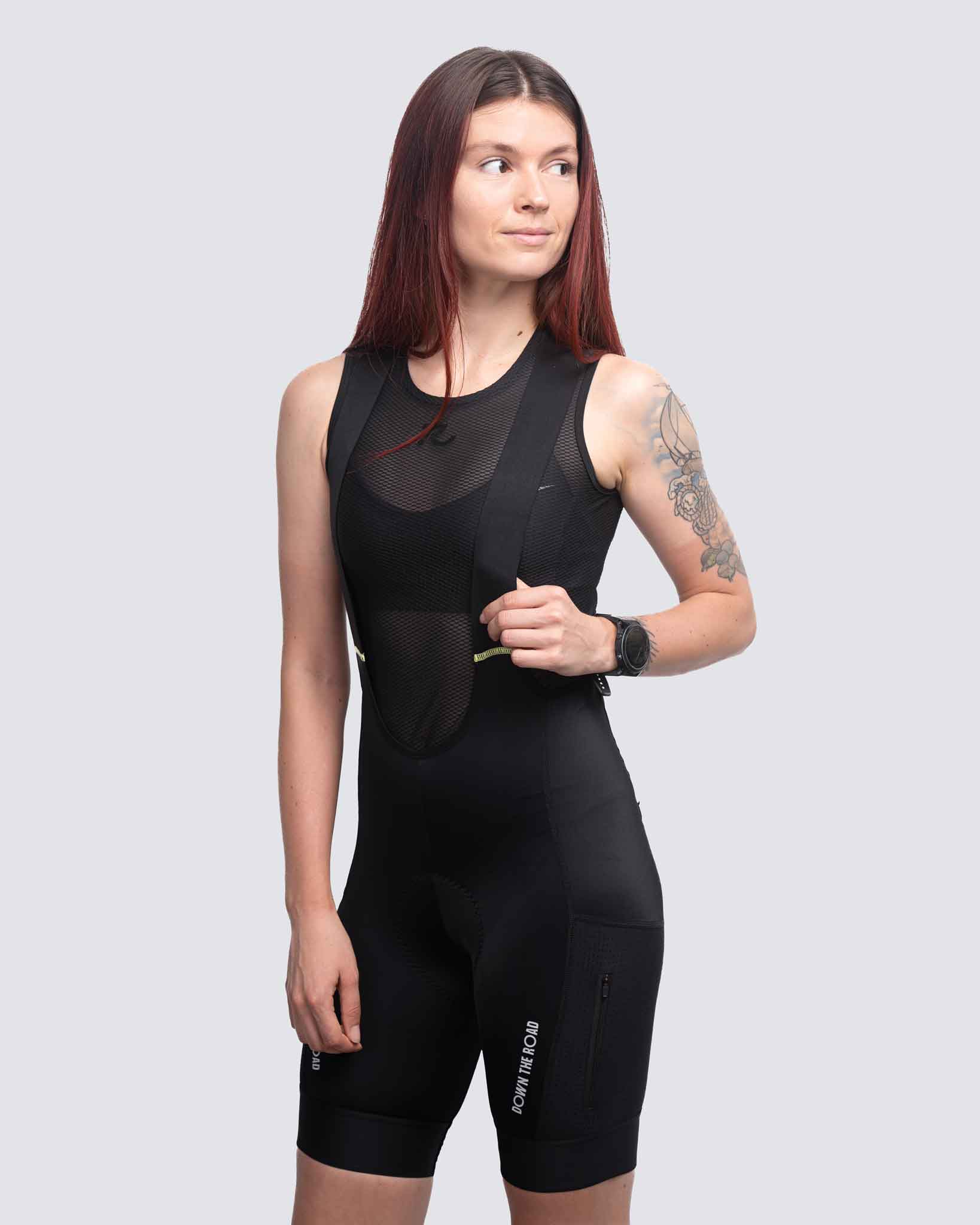 woman cyclist wearing black cargo bibs for gravel cycling