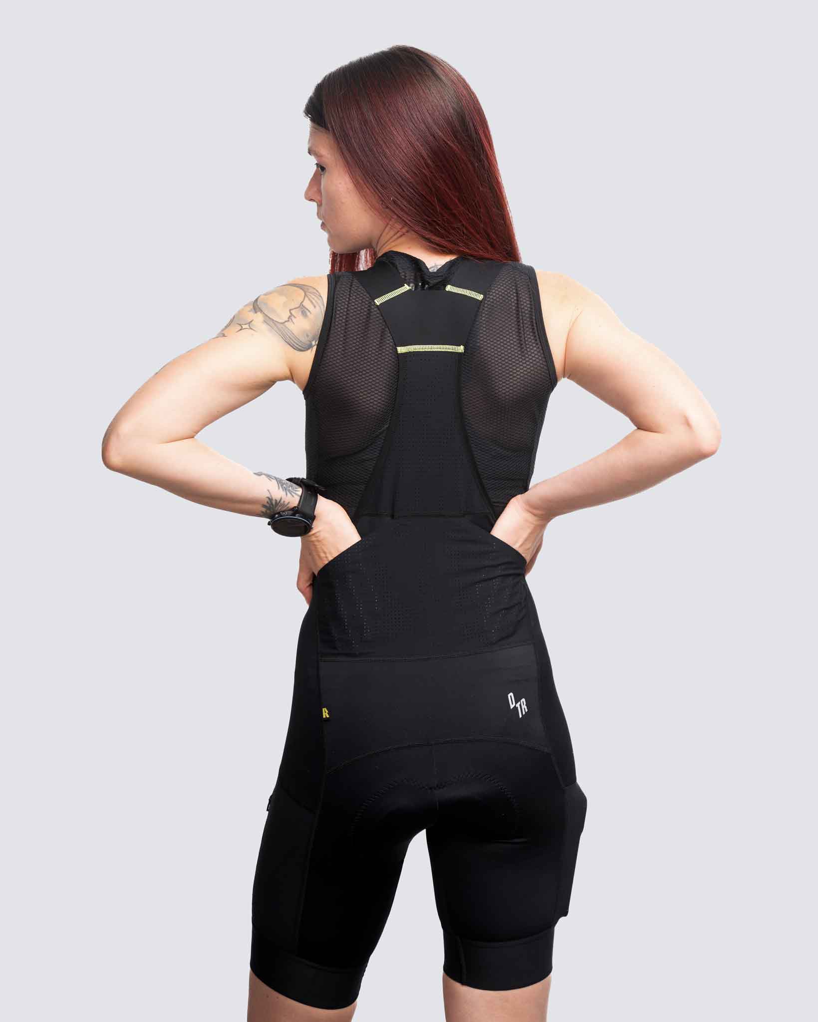 black cargo bibs with two back pockets and a garmin watch