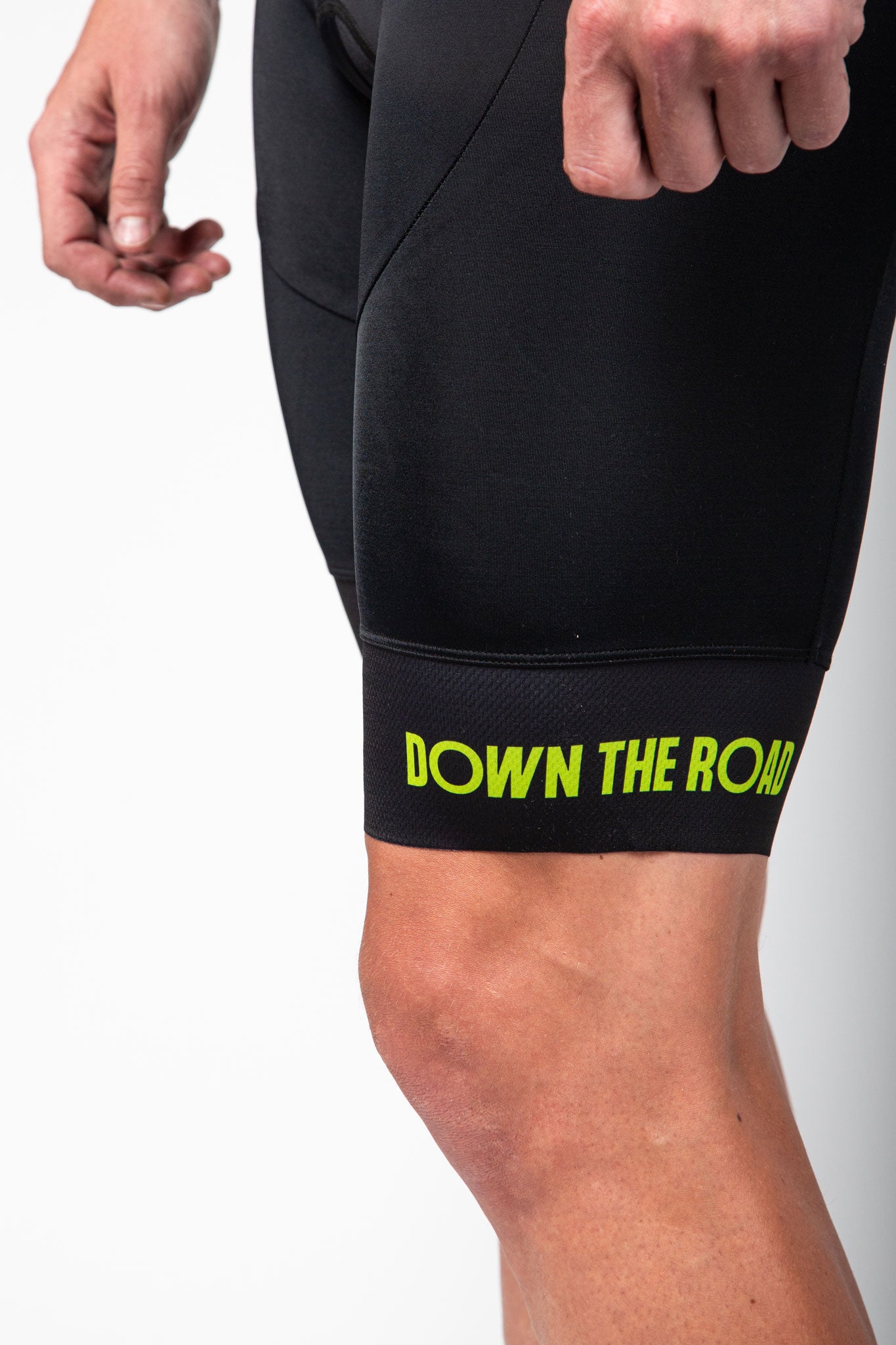black trisuit for men with green details leg close up