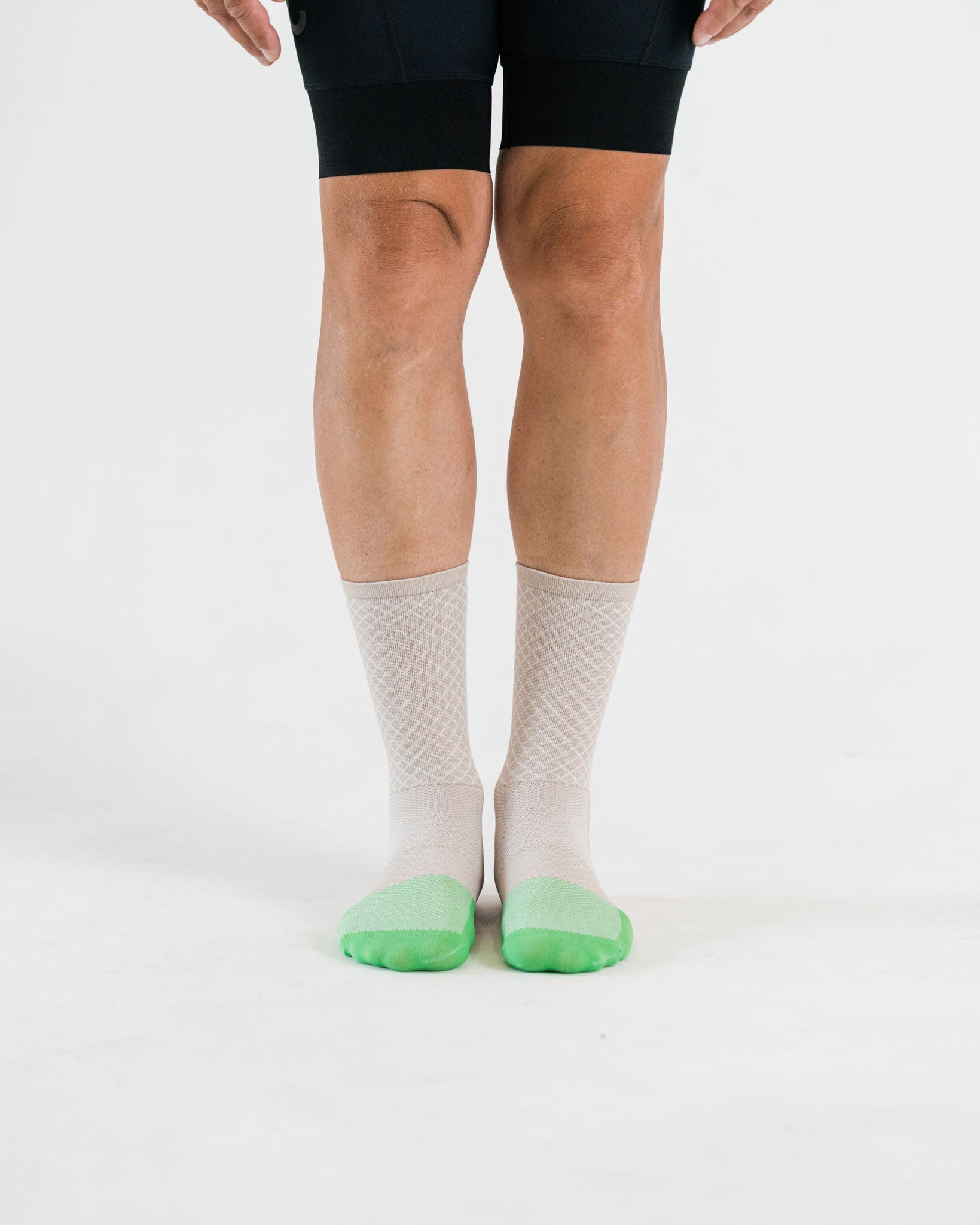 beige cycling socks with green toebox