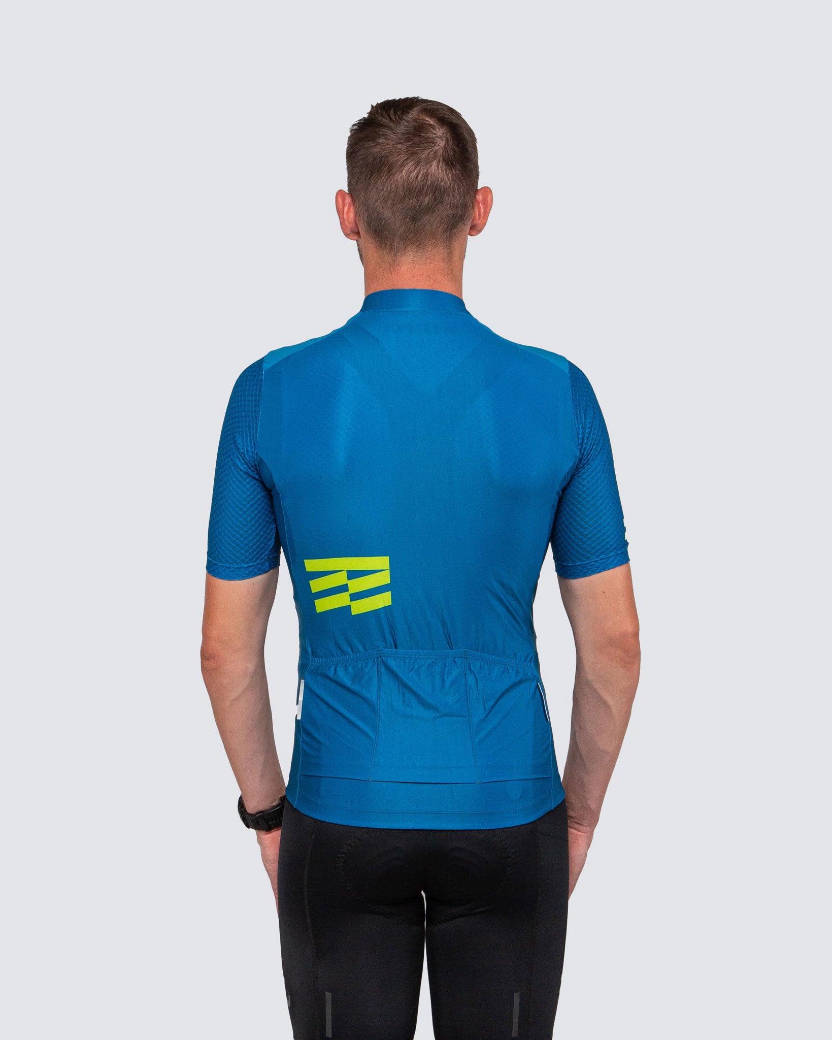back side of man wearing blue cycling jersey