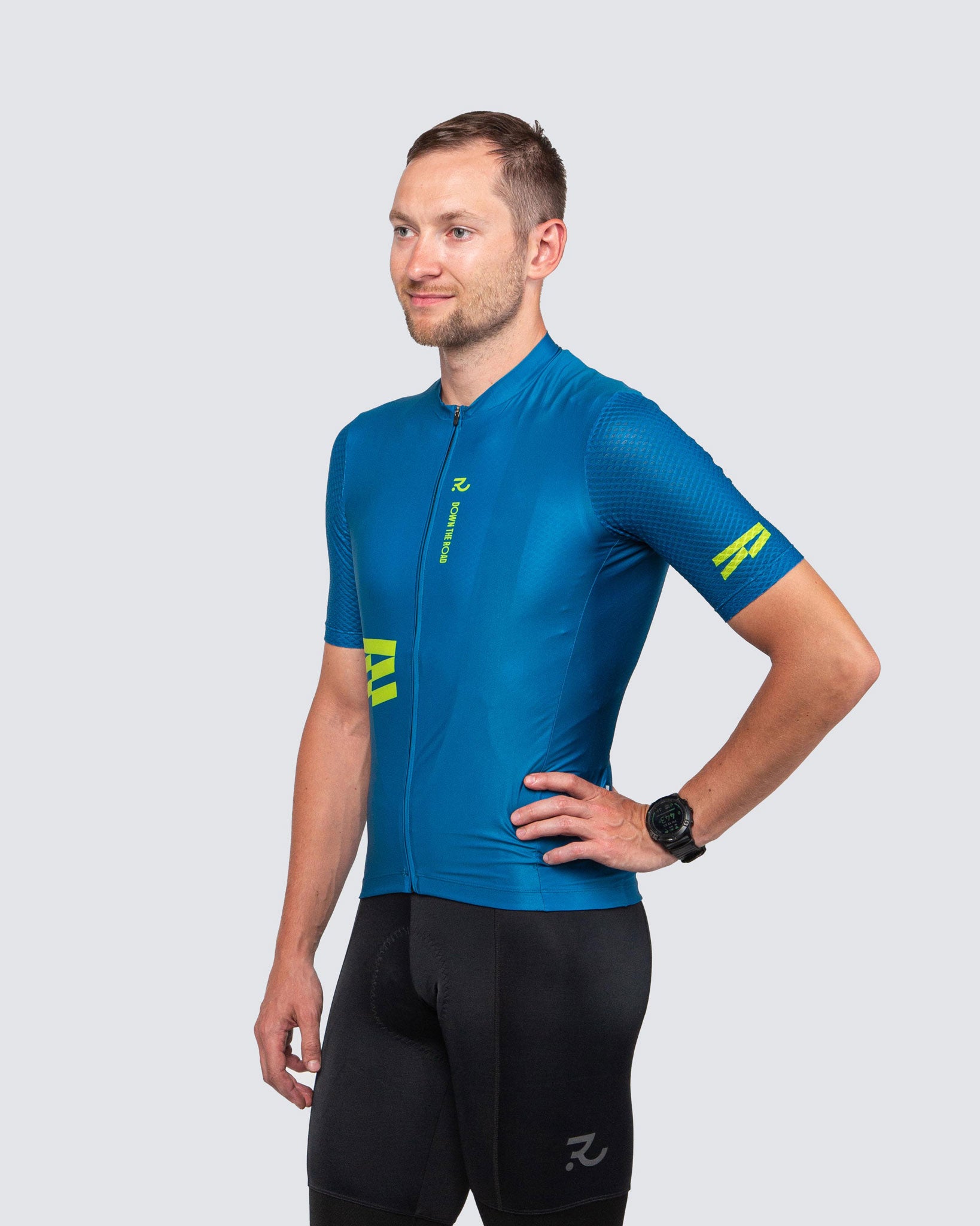 man wearing blue cycling jersey and black bib shorts