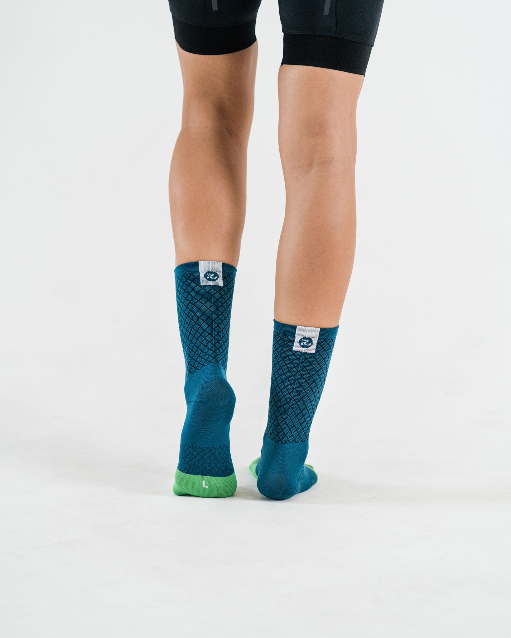 back view of blue cycling socks with down the road details