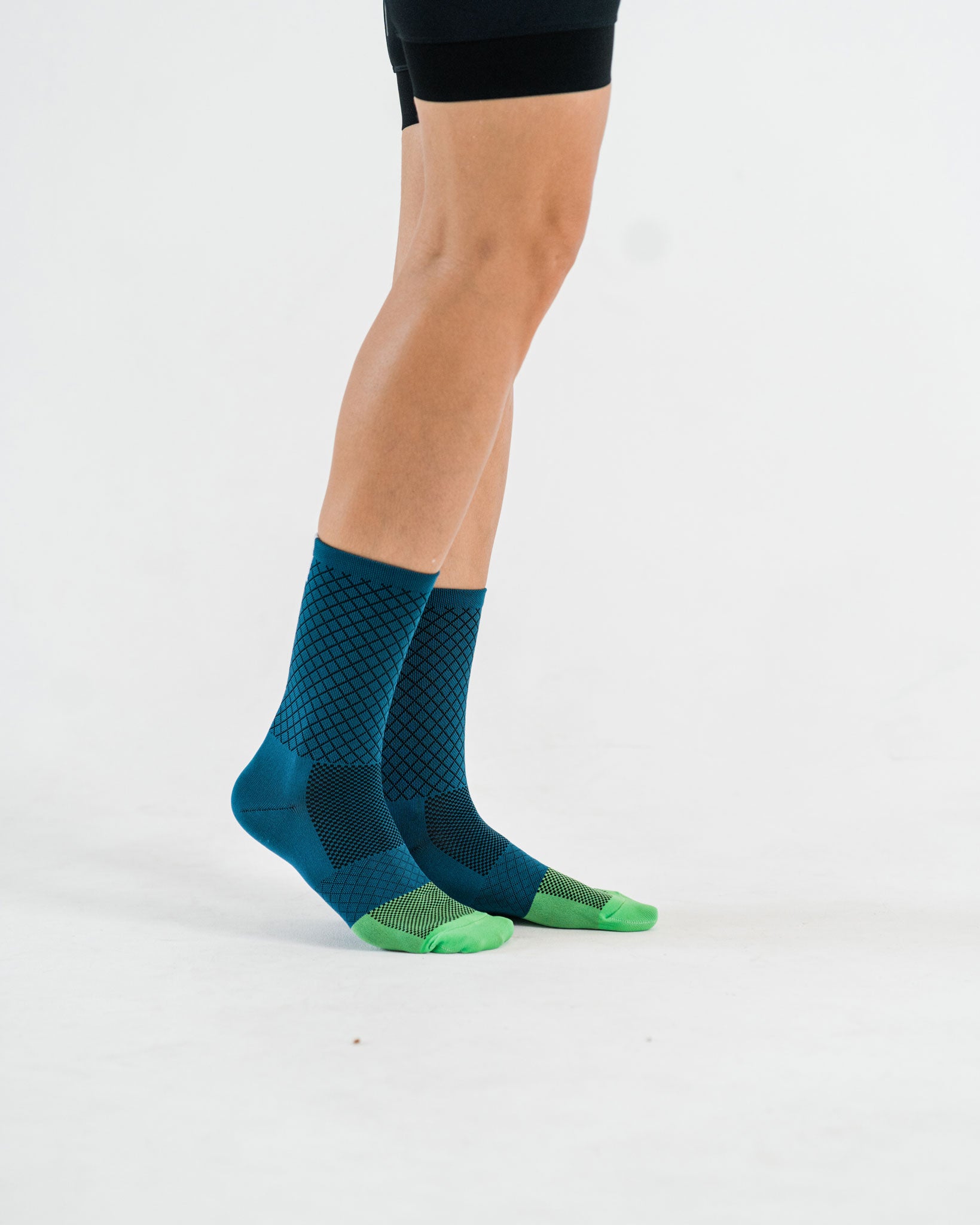side view of blue socks with green toebox