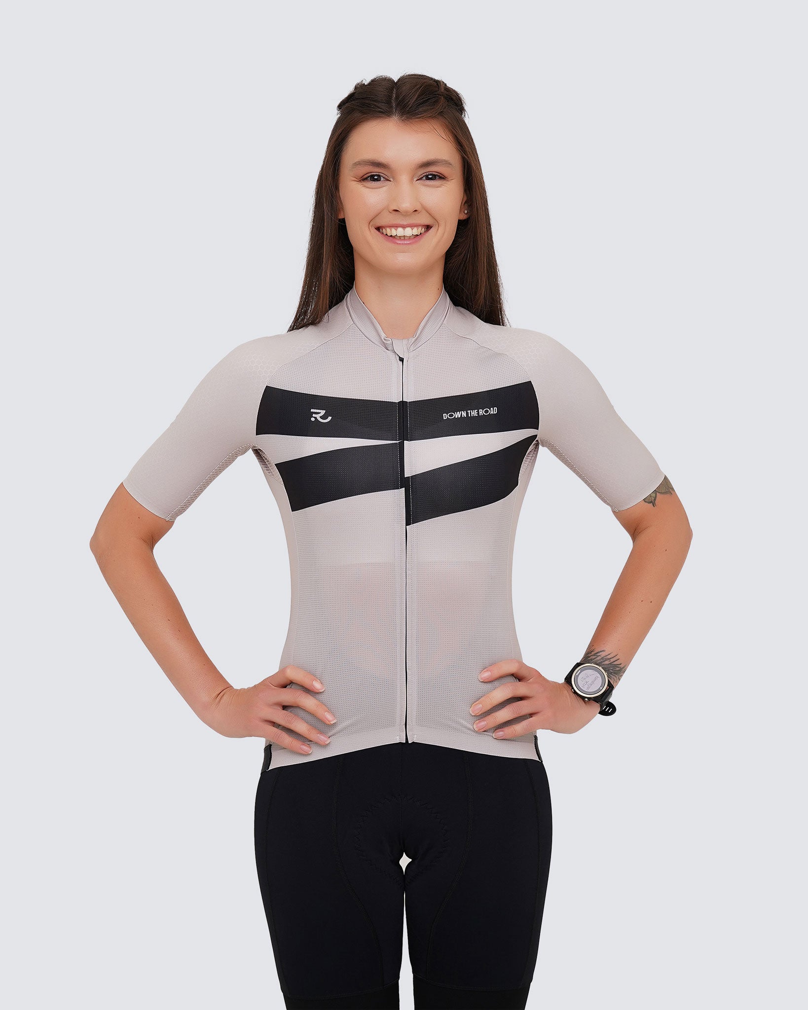 young woman smiling wearing a beige cycling kit