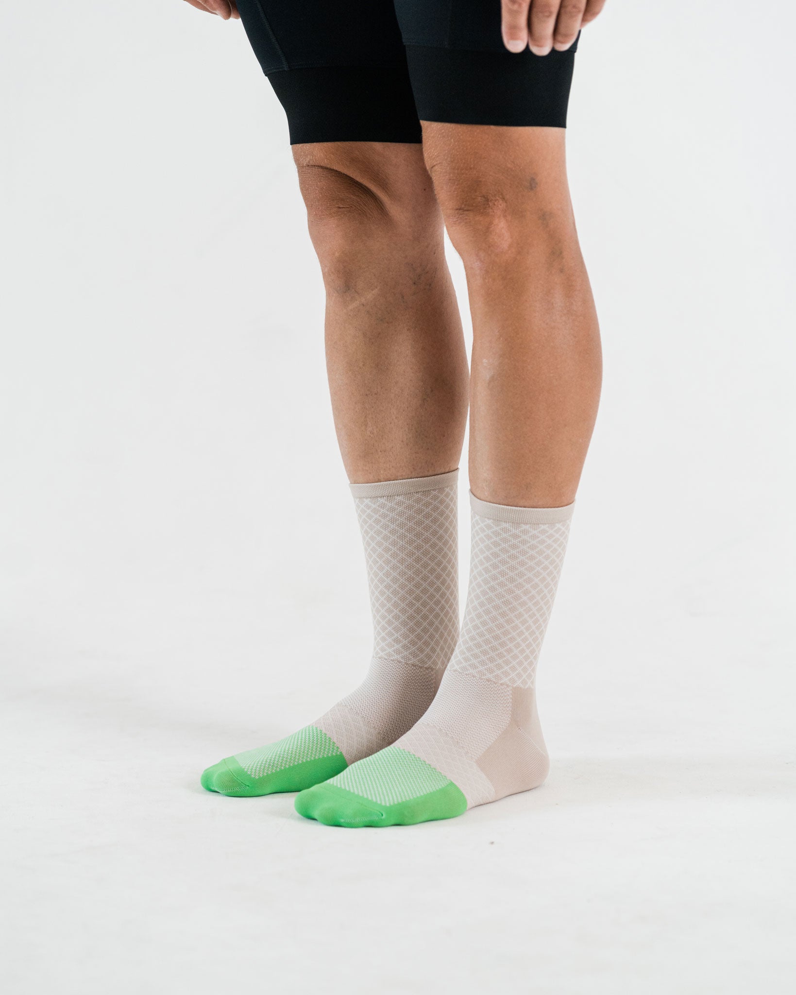 beige cycling socks for men with green toebox and diamong shape pattern