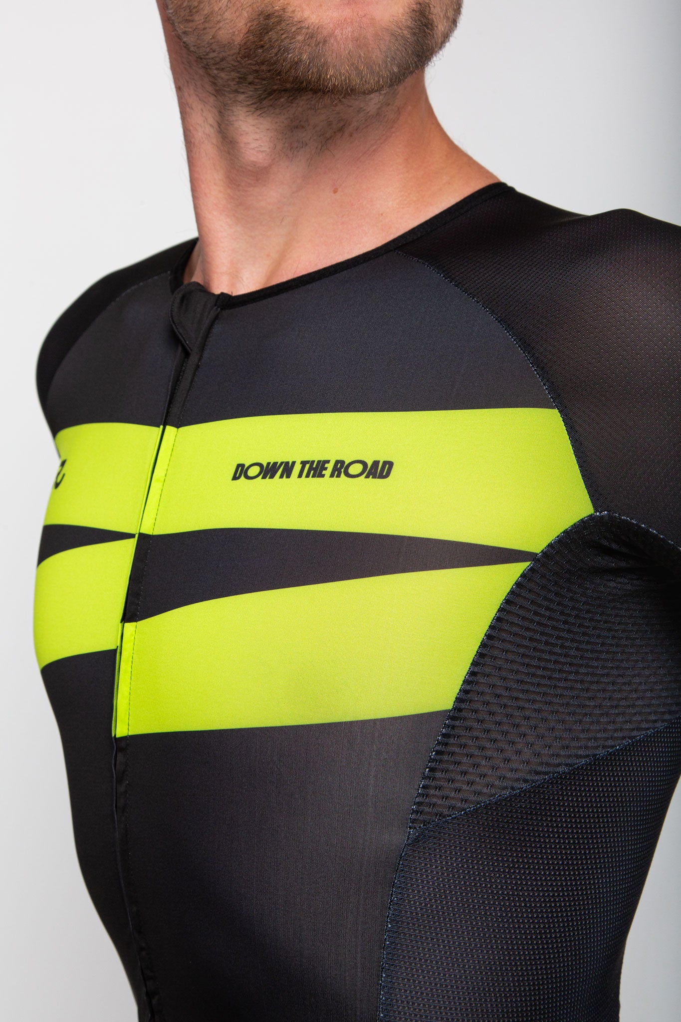 black trisuit for men with green details chest close up view