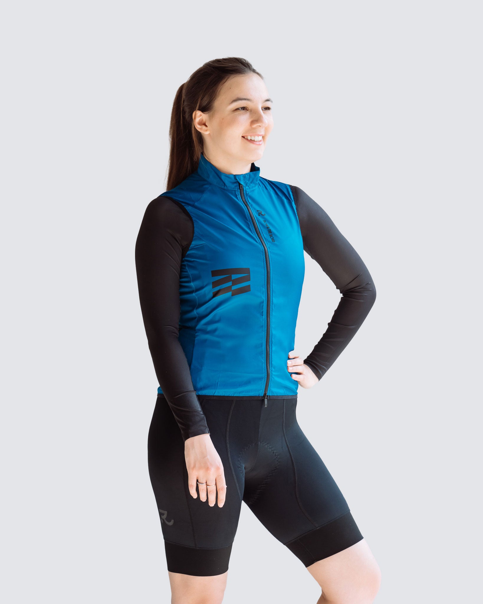 side view of wavy teal cycling vest and bib shorts