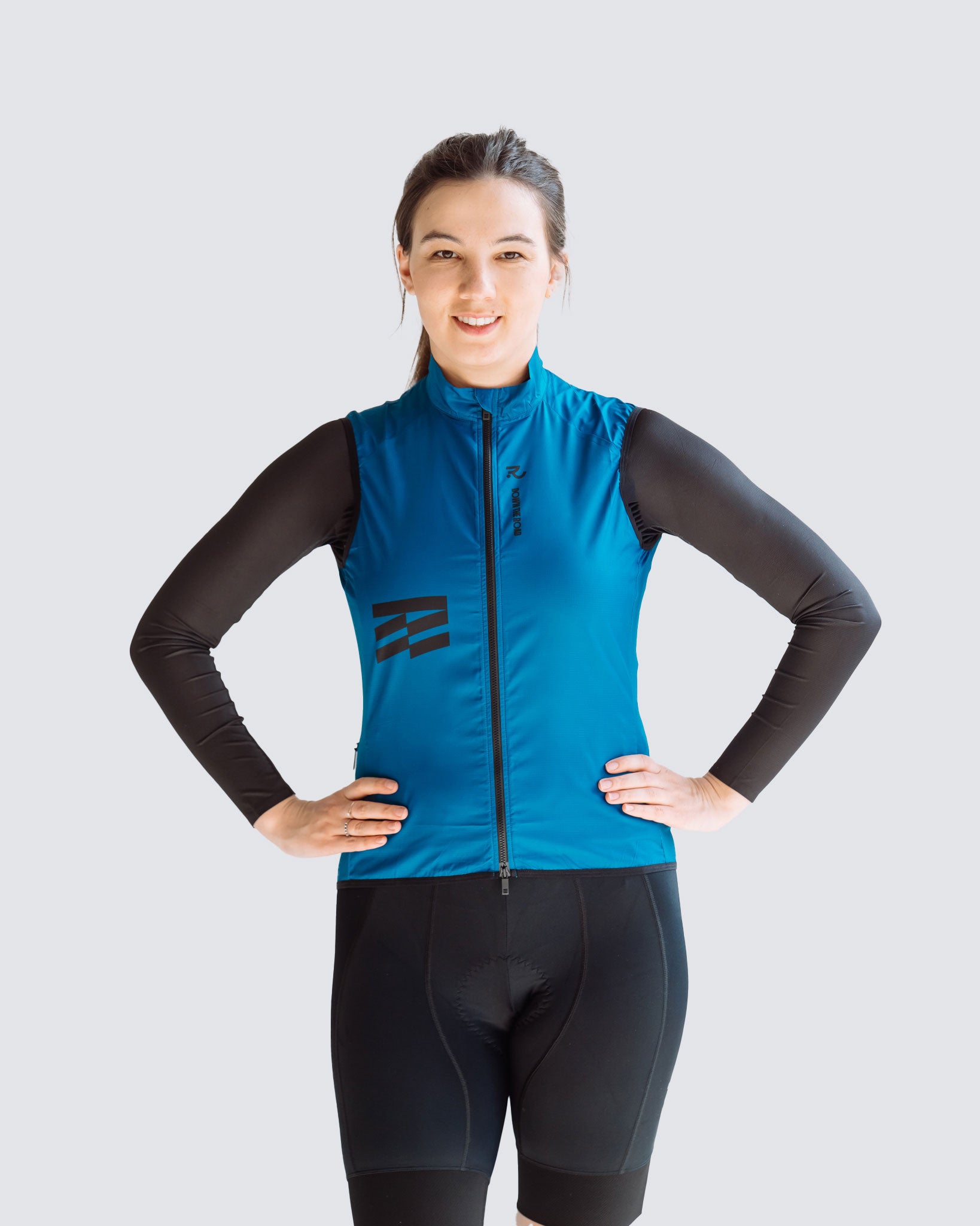 front view of wavy teal vest with a black kit